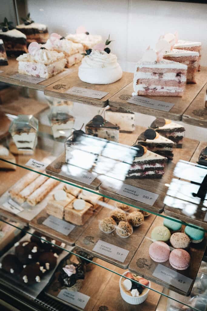 shop glass display with selection of desserts showcased