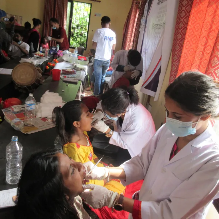 dentists examining patients in a dental camp