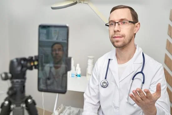 A male doctor recording a video for marketing of his clinic