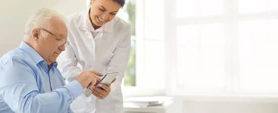 A Dentist showing her mobile to her patient